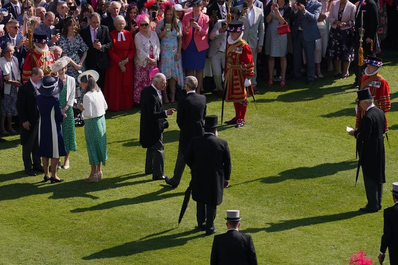 King Charles, centre left, talks with a guest. Getty