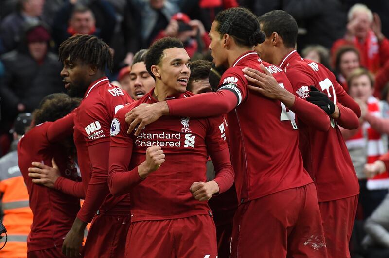 Liverpool's English defender Trent Alexander-Arnold (C) and teammates celebrate after a late own goal from Tottenham Hotspur's Belgian defender Toby Alderweireld (not pictured) during the English Premier League football match between Liverpool and Tottenham Hotspur at Anfield in Liverpool, north west England on March 31, 2019. (Photo by Paul ELLIS / AFP) / RESTRICTED TO EDITORIAL USE. No use with unauthorized audio, video, data, fixture lists, club/league logos or 'live' services. Online in-match use limited to 120 images. An additional 40 images may be used in extra time. No video emulation. Social media in-match use limited to 120 images. An additional 40 images may be used in extra time. No use in betting publications, games or single club/league/player publications. / 
