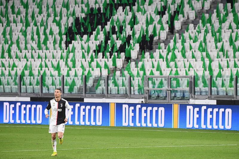 Ronaldo runs on the pitch in an empty stadium. AFP