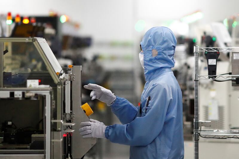 An employee works at a factory of Renesas Semiconductor Co. during a government organised tour of the facility following the outbreak of the coronavirus disease (COVID-19), in Beijing, China May 14, 2020. REUTERS/Thomas Peter