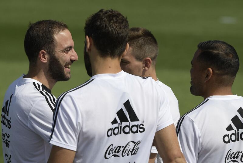 Argentina's forward Gonzalo Higuain, left, jokes with teammates during a training session. Juan Mabromata / AFP
