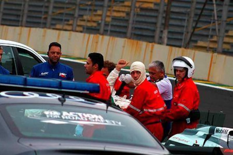Australian driver Mark Webber gives a thumbs up as medical team bring him out of the race track during Sao Paulo's six hours race in Sao Paulo, Brazil, 30 November 2014. This was the last stage of the World Endurance Championship. EPA/Gabriel Pedreschi