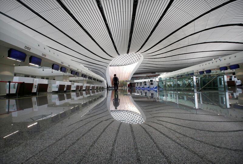 A man walks at the terminal hall of the newly launched Daxing International Airport ahead of the 70th founding anniversary of the People's Republic of China, on the outskirts of Beijing, China. Reuters