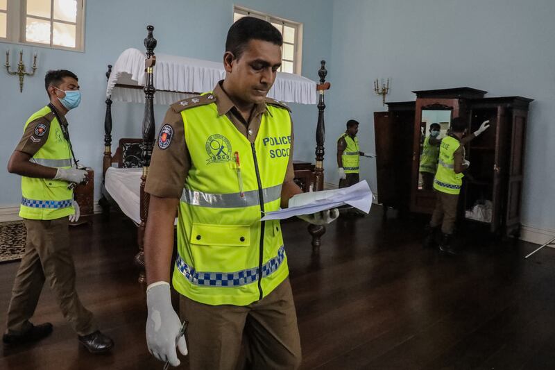 Crime investigation officers in one of the bedrooms at the palace. EPA