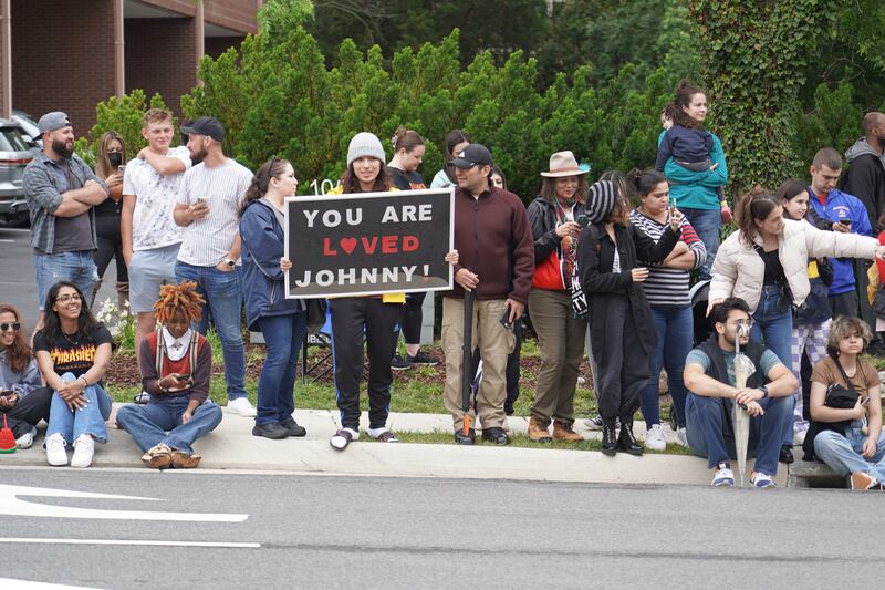 A Depp fan holds a sign saying, 'You are loved, Johnny!' outside the courthouse. Willy Lowry / The National