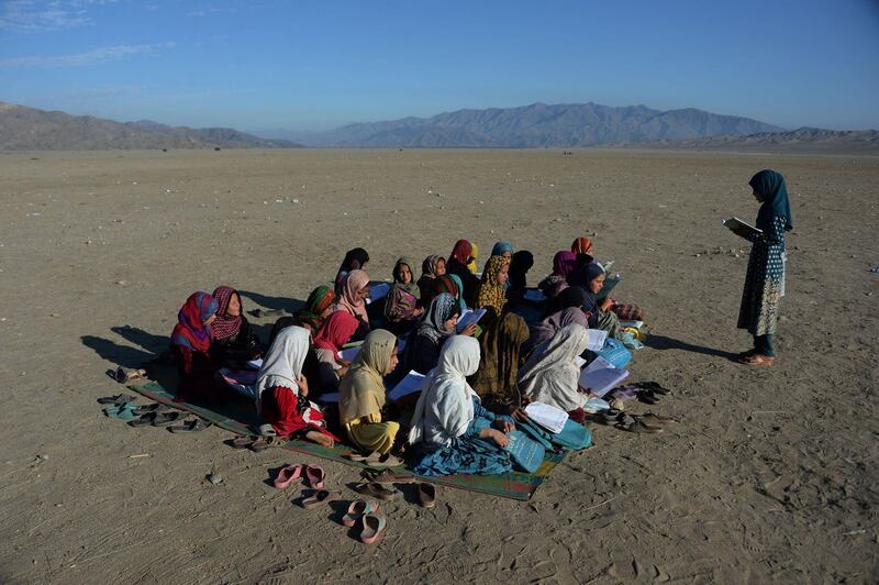 Afghan school children take part in a lesson at an open-air school at the Gambiri Refugee Camp in Laghman province. Noorullah Shirzada / AFP Photo