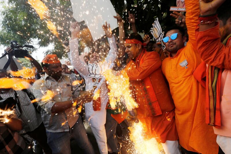 BJP supporters celebrate after learning the initial election results outside the party headquarters in New Delhi, India, May 23, 2019. REUTERS/Adnan Abidi