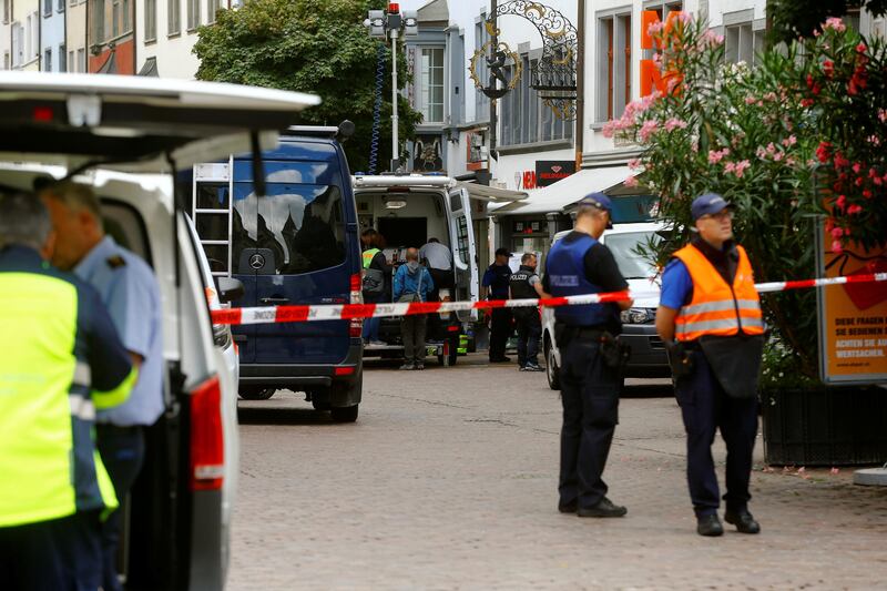 Swiss police officers stand at a crime scene in Schaffhausen, Switzerland July 24, 2017. REUTERS/Arnd Wiegmann