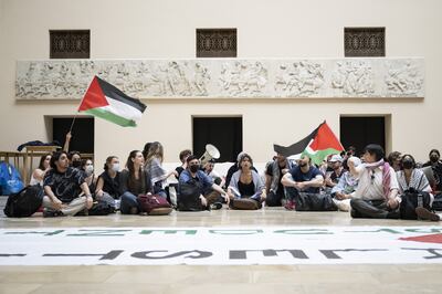 Pro-Palestinian demonstrators protest in the entrance hall of the main building at the University of Zurich. EPA 
