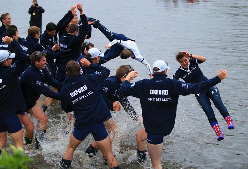 Cox Laurence Harvey, left, of Cambridge and cox Sophie Shawdon of Isis are thrown into the Thames by their crew after victory during the BNY Mellon 160th Oxford versus Cambridge University Boat Race on The River Thames on Sunday in London, England. Richard Heathcote / Getty Images / April 6, 2014  