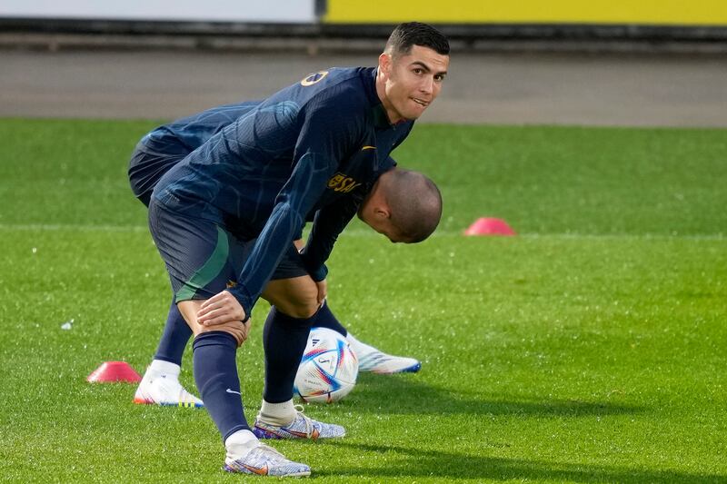 Cristiano Ronaldo stretches with teammate Pepe, in the background, during a Portugal soccer team training session. Ronaldo recently gave a series of explosive interviews with a British talkshow host criticising his club Manchester United. AP Photo