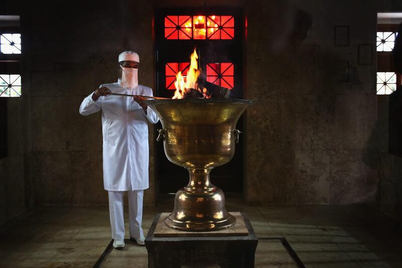 A cleric stokes the coals the ‘sacred eternal flame’ at the Zoroastrian Fire Temple in Yazd, Iran.  
