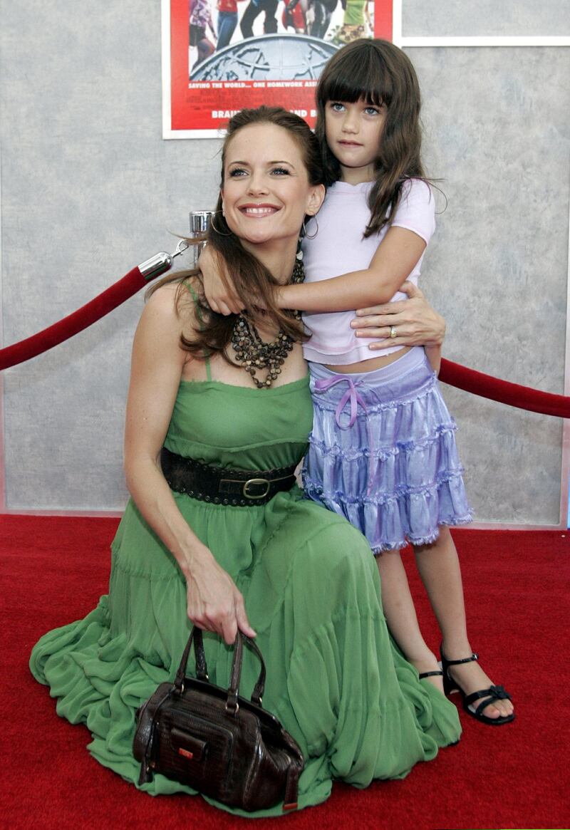 Actress Kelly Preston (L) and her daughter Ella at the worldwide premiere of Walt Disney Pictures' "Sky High" at the El Capitan theatre in Hollywood on July 24, 2005. The film tells the story of an elite high school, Sky High, designated for superpower-gifted students and opens in the United States on July 29, 2005. REUTERS/Mario Anzuoni  MA