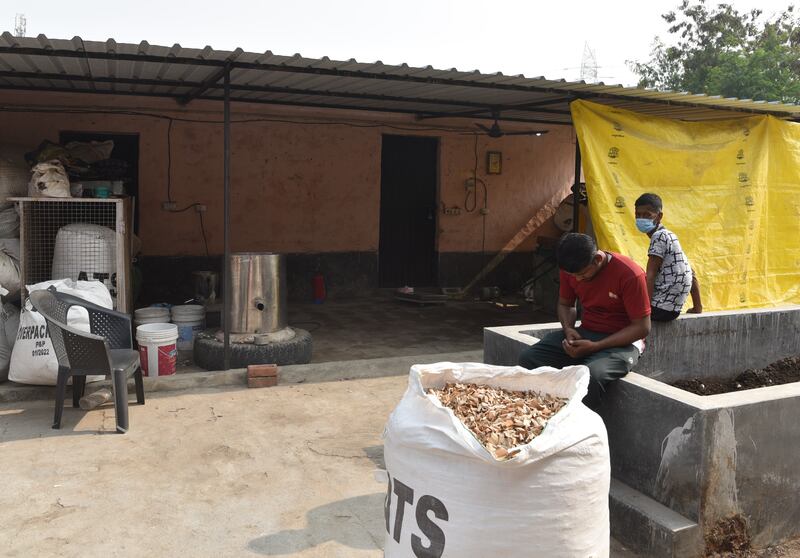 Batches of cigarette butts await processing outside the factory, in Nangli village, Noida
