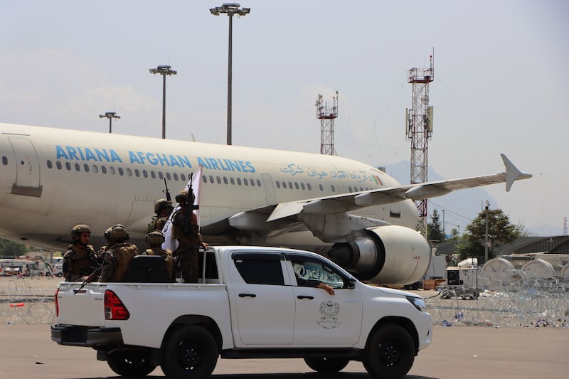 Taliban forces patrol the airport grounds. EPA