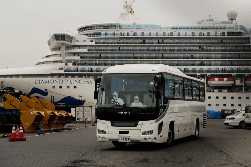 A bus leaves a port where the quarantined Diamond Princess cruise ship is docked on Saturday, February 15, 2020, in Yokohama. AP Photo