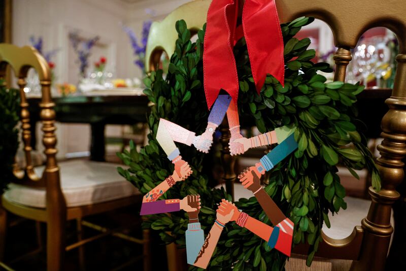 Wreaths of interlocking hands adorn the chairs of a table set with the Obama china in the China Room. Reuters