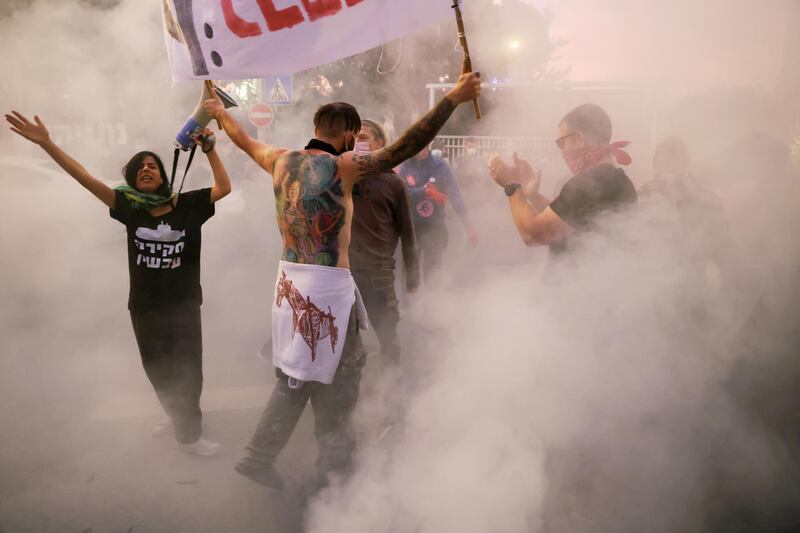 Protesters shout slogans during a demonstration against Israeli Prime Minister Benjamin Netanyahu's alleged corruption, the postponement of his trial and his handling of the coronavirus crisis, outside his residency in Jerusalem. Reuters