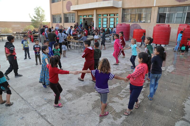 Displaced Kurdish children who fled their home town of Ras al-Ain city play at temporary shelter in a school building at Tal Tamr town, northeast of Syria. Turkey has launched an offensive targeting Kurdish forces in north-eastern Syria, days after the US withdrew troops from the area.  EPA