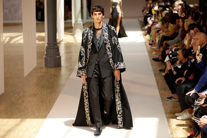 A simple suit is worn with an intricately embroidered kaftan. Reuters