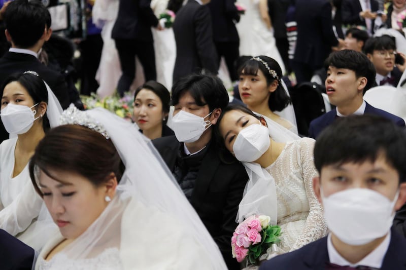 A couple takes a nap before a mass wedding ceremony at the Cheong Shim Peace World Center in Gapyeong, South Korea. AP Photo
