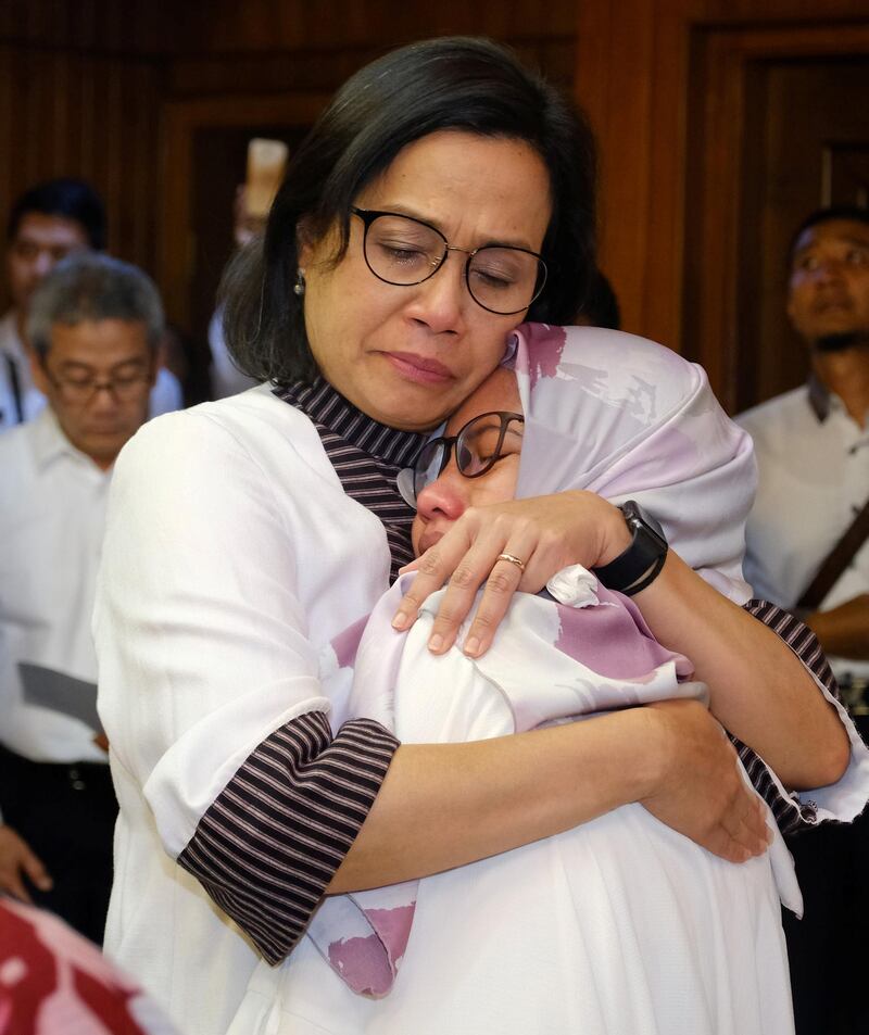 Indonesian Finance Minister Sri Mulyani Indrawati hugs a relative of a victim of the crash. Paruhum Hutauruk