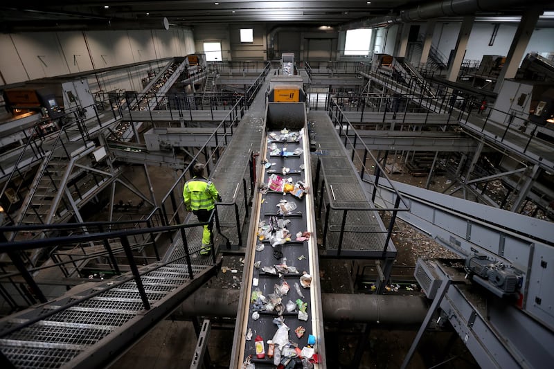 A worker checks the plastic waste at the Interzero recycling plant in Marl, Germany.  EPA 
