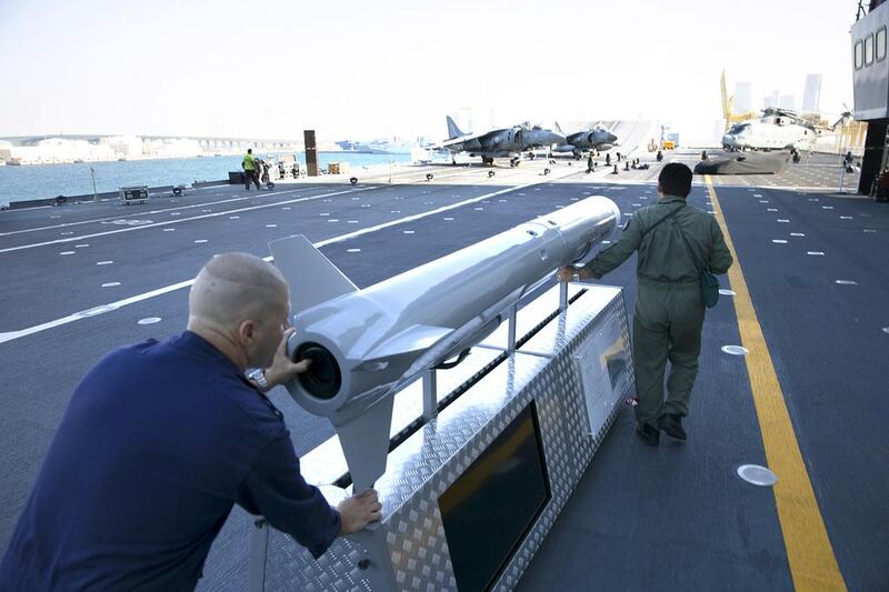 Ship personnel move a display missile aboard the Italian aircraft carrier Cavour. Silvia Razgova / The National
