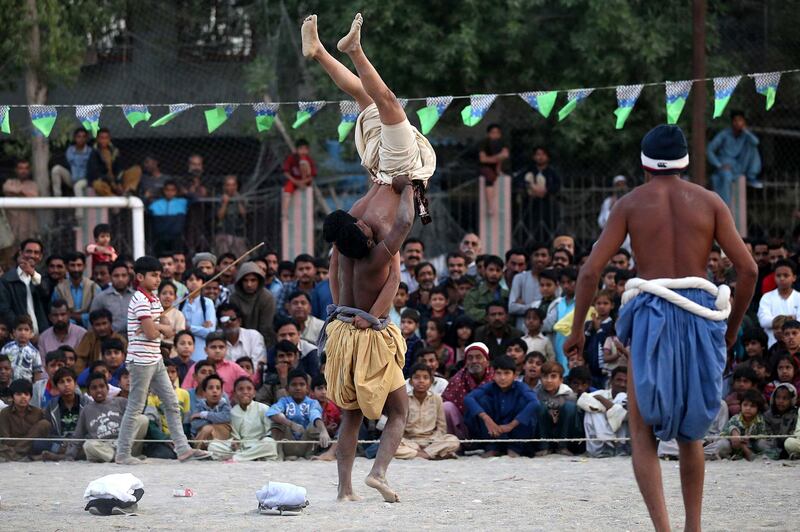'Pehalwans', or wrestlers, in action during a local competition in the outskirts of Karachi, Pakistan, on Friday, 27 December 2019. EPA