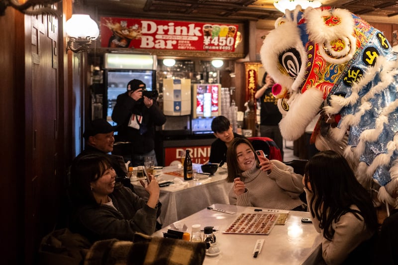 Diners watch a Lion Dance in a restaurant of the Chinatown area of Yokohama, Japan, on the first day of the Lunar New Year of the Dragon. AFP