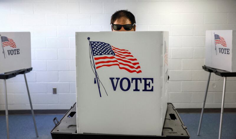 A man marks his ballot during early voting in Lansing,  Michigan. Reuters
