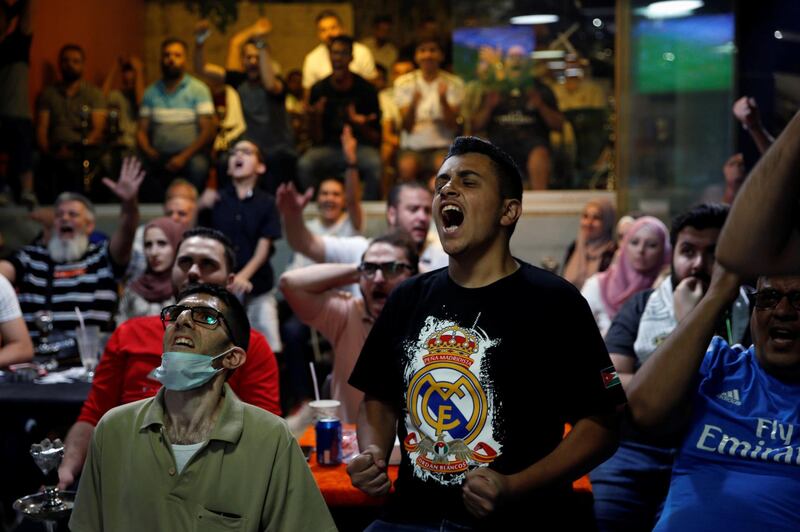 Jordanians watch the Champions League Round of 16 Second Leg - Manchester City v Real Madrid match at a public cafe after the government eased the coronavirus disease (COVID-19) restrictions  in Amman, Jordan, August 7, 2020.  REUTERS/Muhammad Hamed