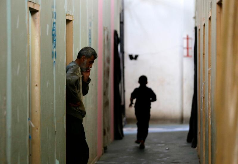 Displaced Syrian civilians gather at a government-run shelter after they were evacuated by the army from areas in the Eastern Ghouta region recently recaptured from rebels by government forces in Ad Duwayr on outskirts of Damascus.  Louai Beshara / AFP