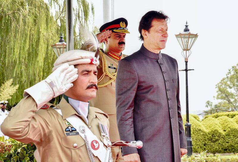 In this handout photograph released by the Press Information Department (PID) on August 18, 2018, newly appointed Pakistani Prime Minister Imran Khan inspects guard of honor on his arrival in the Prime Minister House during a ceremony in Islamabad. 
Pakistan's new Prime Minister Imran Khan was sworn in at a ceremony in Islamabad on August 18, ushering in a new political era as the World Cup cricket hero officially took the reins of power in the nuclear-armed country. / AFP PHOTO / PID / Handout / RESTRICTED TO EDITORIAL USE - MANDATORY CREDIT "AFP PHOTO / PID " - NO MARKETING NO ADVERTISING CAMPAIGNS - DISTRIBUTED AS A SERVICE TO CLIENTS