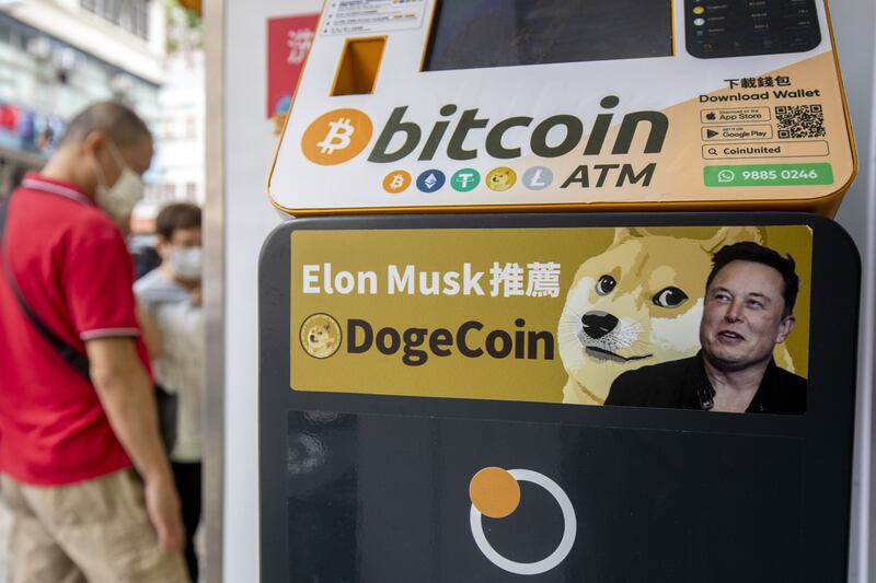A sticker advertising Dogecoin on a cryptocurrency automated teller machine at a laundromat in Hong Kong. Bloomberg