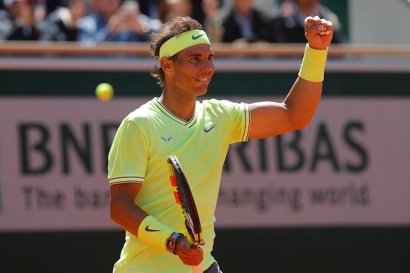 Spain's Rafael Nadal celebrates winning after Switzerland's Roger Federer's ball went out, rear left, during their semifinal match of the French Open tennis tournament at the Roland Garros stadium in Paris, Friday, June 7, 2019. (AP Photo/Michel Euler)