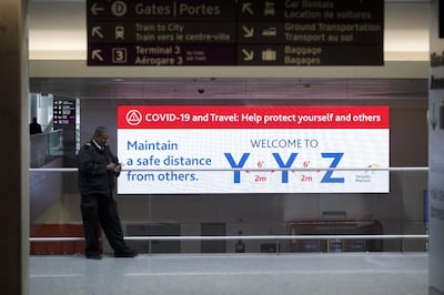 A public service announcement for Covid-19 is displayed on a screen at Toronto Pearson International Airport (YYZ) in Toronto, Ontario, Canada, on Wednesday, April 8, 2020. The airport is now averaging 200 flights per day, down from 1,200 before the Covid-19 pandemic, CTV News reported. Photographer: Cole Burston/Bloomberg