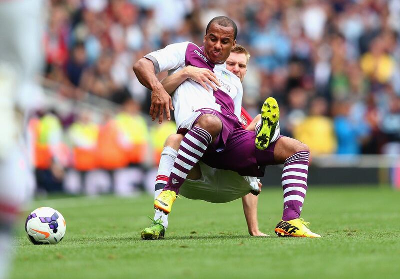 LONDON, ENGLAND - AUGUST 17: Gabriel Agbonlahor of Aston Villa is challenged by Per Mertesacker of Arsenal during the Barclays Premier League match between Arsenal and Aston Villa at Emirates Stadium on August 17, 2013 in London, England. (Photo by Clive Mason/Getty Images) *** Local Caption ***  176694249.jpg