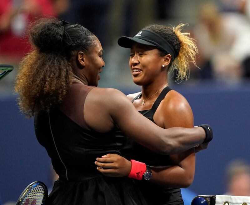 TOPSHOT - Naomi Osaka of Japan (R) and Serena Williams of the US meet at the net after  their 2018 US Open women's singles final match on September 8, 2018 in New York. - Osaka, 20, triumphed 6-2, 6-4 in the match marred by Williams's second set outburst, the American enraged by umpire Carlos Ramos's warning for receiving coaching from her box. She tearfully accused him of being a "thief" and demanded an apology from the official. (Photo by Eduardo MUNOZ ALVAREZ / AFP)