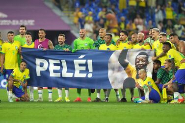 Brazil players bring a Pele banner on to the pitch following the FIFA World Cup Round of Sixteen match at Stadium 974 in Doha, Qatar. Picture date: Monday December 5, 2022.