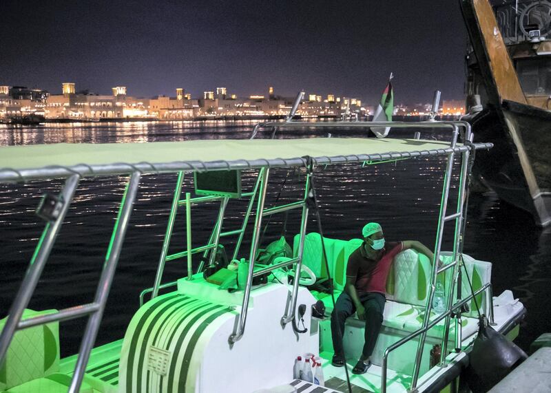 DUBAI, UNITED ARAB EMIRATES. 2 JUNE 2020. 
A man sits in a boat, waiting for customers in Baniyas, Deira.
(Photo: Reem Mohammed/The National)

Reporter:
Section: