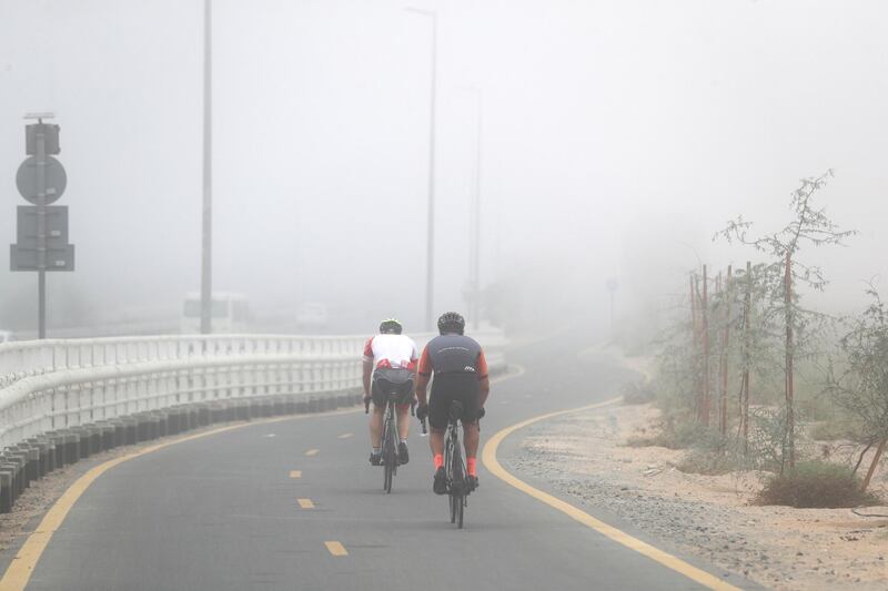 Dubai, United Arab Emirates - Reporter: N/A. News. Cyclists on the Al Qudra cycle path in the fog. Thursday, April 8th, 2021. Dubai. Chris Whiteoak / The National