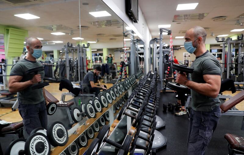 A man wearing a protective face mask works out in a gym in Rome, Italy. Reuters