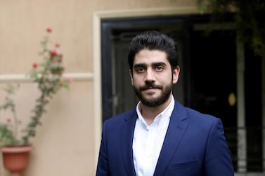 Abdullah Morsi, the youngest son of Egypt's jailed former Islamist President Mohamed Morsi, poses for a photograph in front of his home in Cairo, Egypt. AP