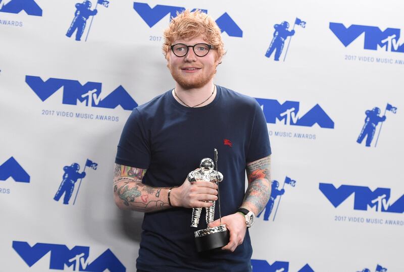 Ed Sheeran poses in the press room with the award for artist of the year. Jordan Strauss / Invision / AP