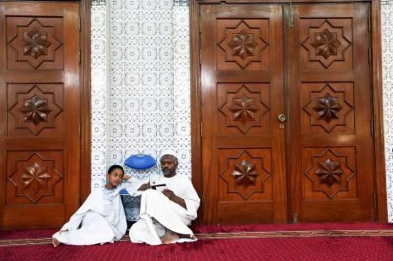 The National /Rich-Joseph Facun (August 19, 2011) Ibrahim  Murtada (CQ), 14, left, spends time at a mosque with his father Murtada Ibrahim (CQ), right, Friday, August 19, 2011 in Abu Dhabi. 