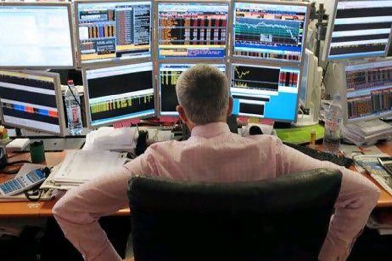 Hard to see the forest for the screens: a broker tracks shares on multiple computers. Taking a long-term view of your stock portfolio is one way to survive market turbulence. Eric Piermont / AFP