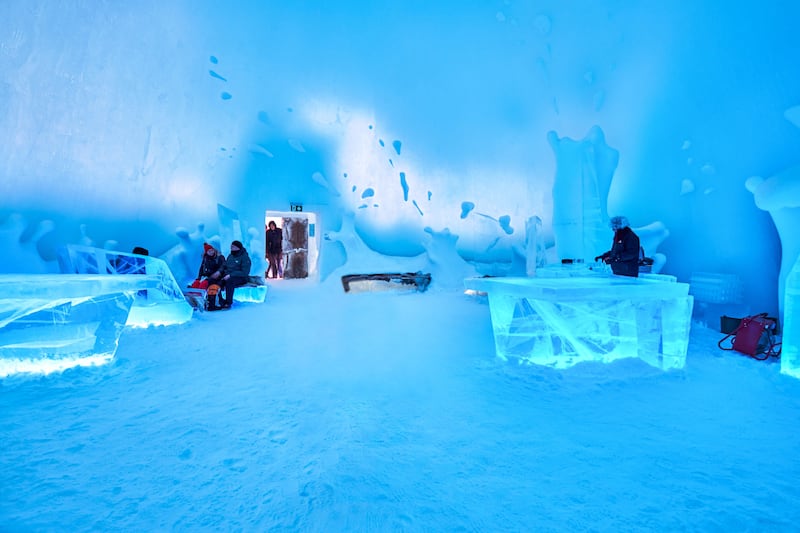 Tourists at Ice Bar at the Ice Hotel in Jukkasjarvi, Sweden.