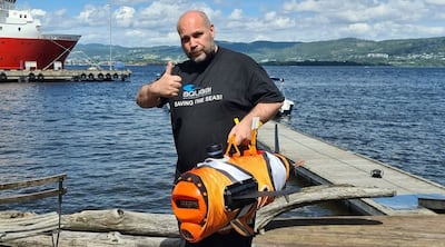 Aquaai co-founder Simeon Pieterkosky holds one of the company's clownfish robots designed to collect data under water. Photo: Aquaai