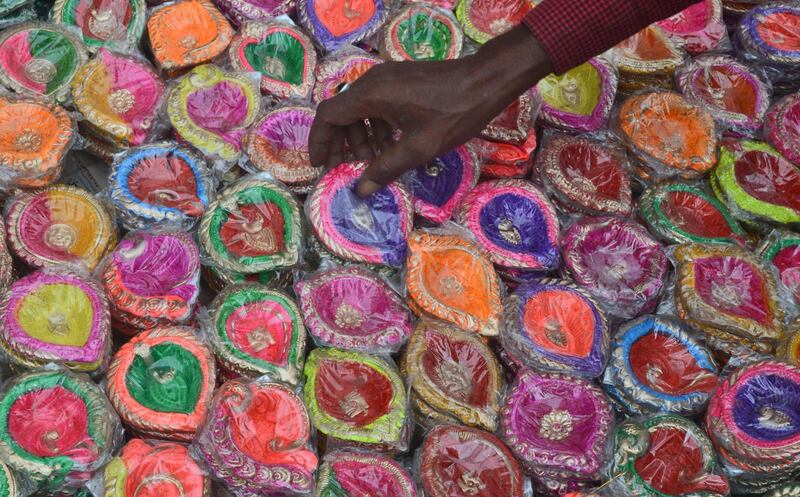 A vendor arranges designer lamps in a market on the eve of Diwali in Guwahati, India. EPA